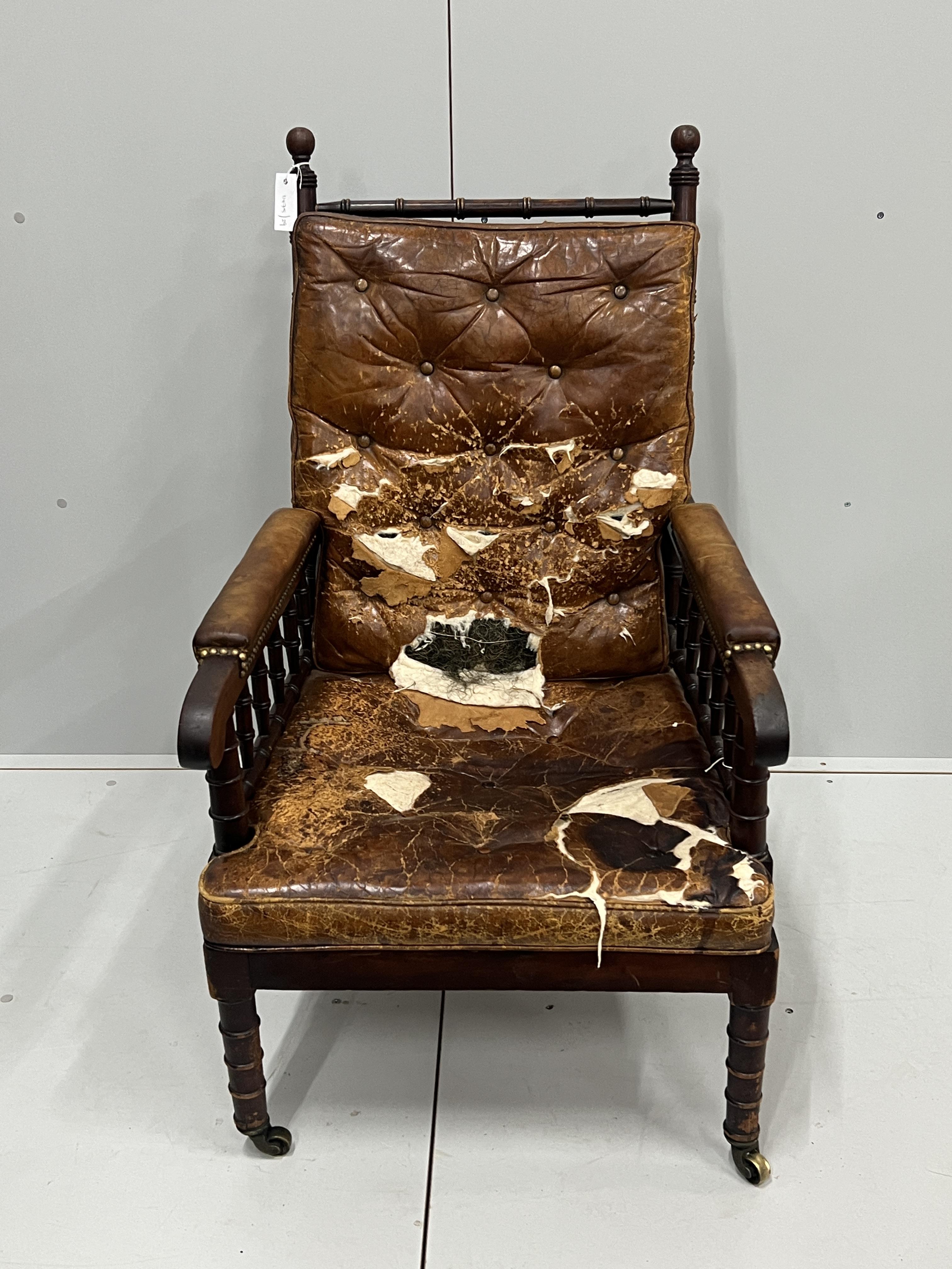 An early Victorian turned mahogany library chair with distressed leather cushion seat and back, width 62cm, depth 66cm, height 104cm